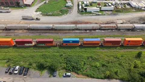 Drone shot flying over a moving freight train carrying intermodal cargo Stock Footage 343807135