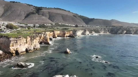 Drone Shot Flying Over Ocean Waves Crashing Against Cliff Video stock 205536140