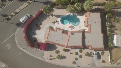 Drone Shot flying over odd shaped swimming pools in Palm Desert Stock Footage 91674683