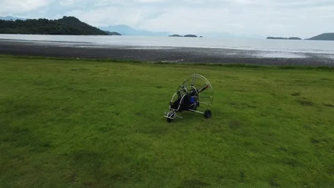Drone shot flying over parked paramotor on the Jabaquara Beach in Paraty 스톡 동영상 328349612