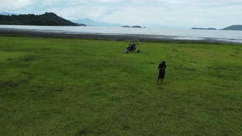 Drone shot flying over parked paramotor and passenger in Paraty, Brazil Video stock 328349620