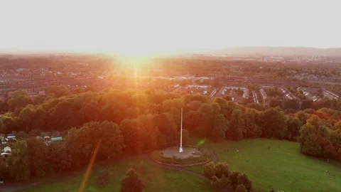 A drone shot flying over Queen's Park, Glasgow at sunset/ Stock Footage