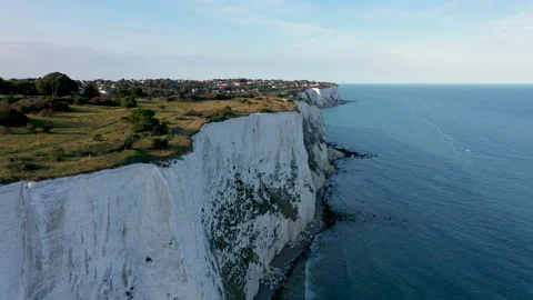 Drone shot flying over white cliffs to the sea revealing coastline. 4k Stock Footage 147364427