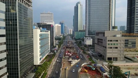 Drone shot flying through central Jakarta, construction site underground metro Stock Footage 78572946