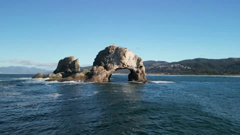 Drone Shot Flying Through Twin Rocks Arch on Sunny Day with 2 Bald Eagles on Top Stock Footage 228748101