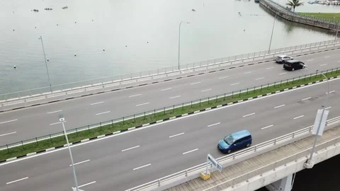 Drone shot flying towards bridge with cars driving, camera tilt down (Singapore) Stock Footage 329052001