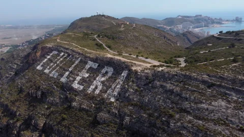 Drone shot flying towards the huge "Cullera" sign. Stock Footage 258284537