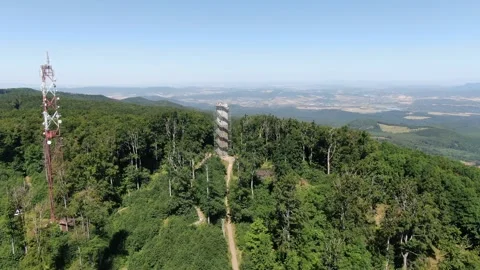 Drone Shot Flying Towards Watchtower Surrounded by Lush Trees 動画素材 337305250