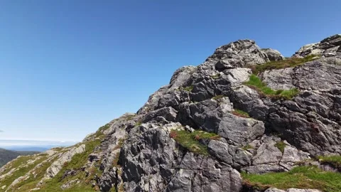 Drone shot flying up Ulriken mountain cliffs in Bergen Norway, July 2026 Stock Footage 340080136