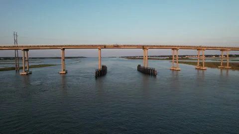 Drone shot flying underneath a high rise bridge on the inter coastal Stock Footage 243192266