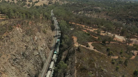 Drone shot following a mining train in a deserted valley 스톡 동영상 134584329