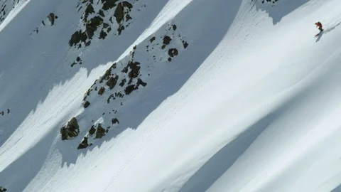 Drone shot of freeride skier shredding big mountain in Iceland on sunny day Stock Footage 124227134