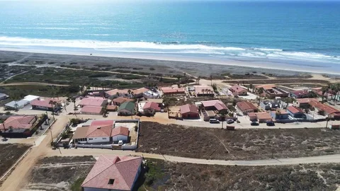 Drone shot of front beach community on a beautiful beach in 4k Video stock 128943978