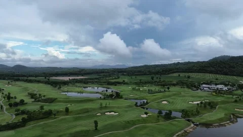 Drone shot of a golf course with lush greens, ponds, bunkers Stock Footage 278943966
