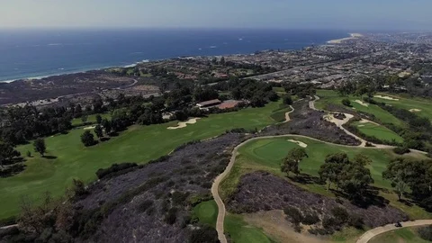 Drone shot of the golf course next to the ocean Stock Footage 84558159