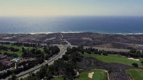Drone shot of the golf course next to the ocean Stock Footage 84567126