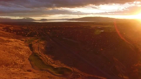 Drone shot of golf course next to mountains during sunset Stock-Footage 127463517