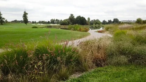 A drone shot of a golf field Видео 115992710