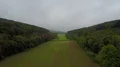 Drone shot gray clowdy foggy weather low mountain range valley forest 4k or 4k+ Resolution