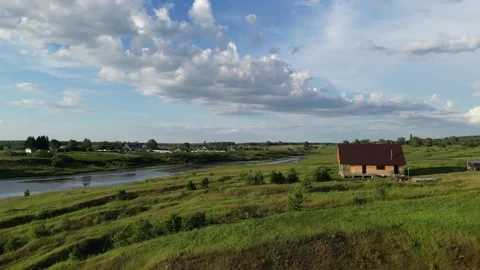 Drone shot of a green edge with trees and a river in summer on a sunny day Stock Footage 227128463