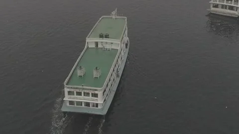 Drone shot of green ferry on river in Dhaka, Bangladesh Видео 244654571