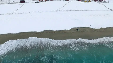 Drone shot a guy surf in Lofoten, Norway, around Stock Footage 71836504