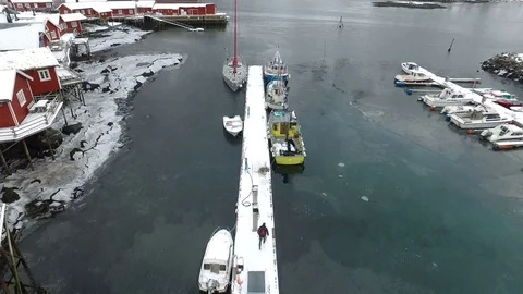 Drone shot of a guy walking to his boat in Lofoten, Norway Stock Footage 71836900