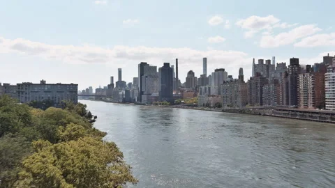 Drone Shot of Harlem River with Manhattan Skyline and Greenery Stock Footage 283927770