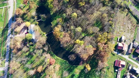 Drone shot from high above of a small river with a medieval castle on the bank Stockbeeldmateriaal 223829731