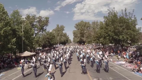 Drone shot of high school marching band on parade route in summer Video stock 231511320