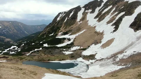 Drone shot of the highest mountain lake in Ukraine is Berbeneskul. Ukrainian Stock Footage 168525089