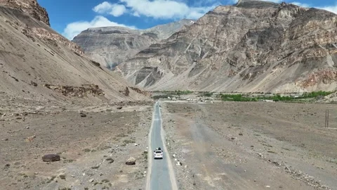 Drone Shot of Highway Passing Through Himalayan Mountain Valley with Vehicle Stock Footage 330319518