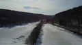 Drone shot hills and valley white farmland winter landscape in mountain range 4k or 4k+ Resolution