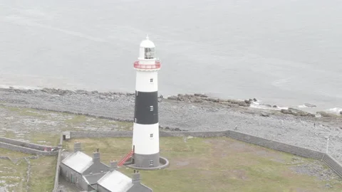 Drone shot of Historic Lighthouse on Aran Island, Ireland Stock Footage 224819443