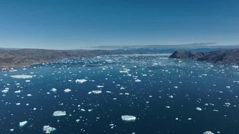 Drone shot of icebergs floating in a large fjord of East Greenland Video stock 332370918