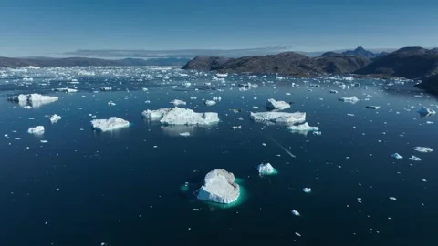 Drone shot of icebergs floating in a large fjord of East Greenland Stock Footage 332371249