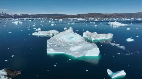 Drone shot of icebergs floating in a large fjord of East Greenland Stock Footage 332371574
