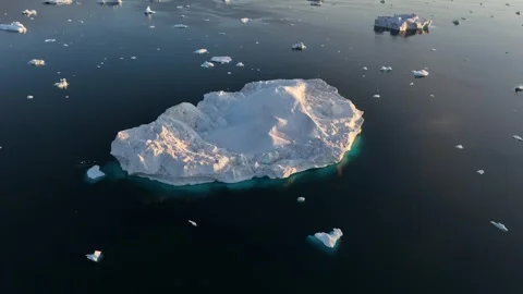 Drone shot of icebergs floating in a large fjord of East Greenland Video stock 332373447