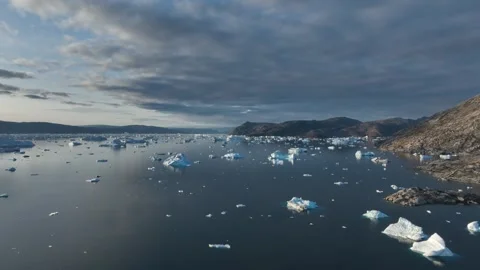 Drone shot of icebergs floating in a large fjord of East Greenland Stock-Footage 332373679