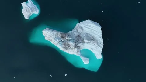 Drone shot of icebergs floating in a large fjord of East Greenland Stock Footage 332374836