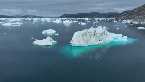 Drone shot of icebergs floating in a large fjord of East Greenland Stock Footage 332375618