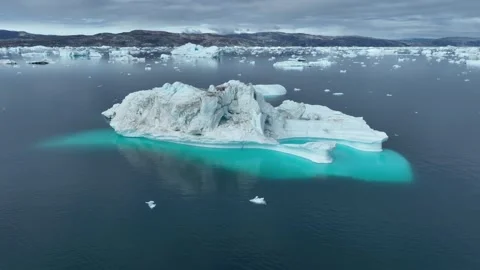 Drone shot of icebergs floating in a large fjord of East Greenland Stock Footage 332375944
