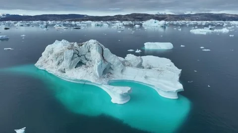 Drone shot of icebergs floating in a large fjord of East Greenland Stock Footage 332376145