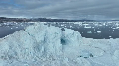 Drone shot of icebergs floating in a large fjord of East Greenland Stock Footage 332376473