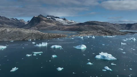 Drone shot of icebergs floating in a large fjord of East Greenland Video stock 332377794