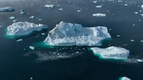 Drone shot of icebergs floating in a large fjord of East Greenland Video stock 332378287