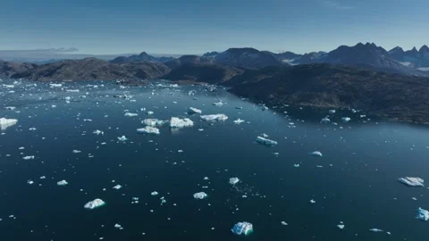 Drone shot of icebergs floating in a large fjord of East Greenland Stock-Footage 332382414