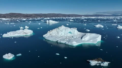 Drone shot of icebergs floating in a large fjord of East Greenland Stock-Footage 332382450