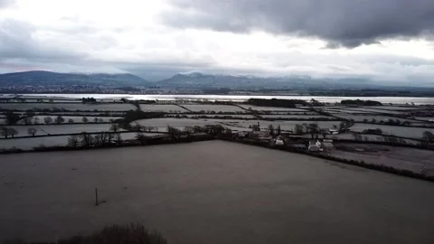 Drone shot of icy fields next to Snowdonia Stock Footage 199423273