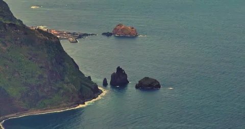 Drone shot of the Ilheus da rib arch, on the coastline of Ribeira da Janela Stock Footage 270362296